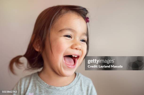 laughing toddler girl headshot - children face stock pictures, royalty-free photos & images