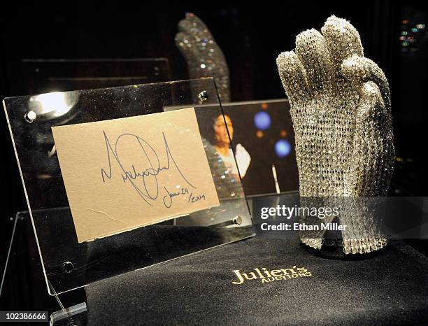 An autograph from Michael Jackson on a cut piece of an album cover dated June 24, 2009 - one day before the singer died - is displayed next to a...