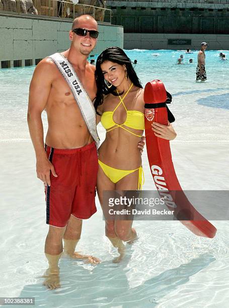 Lifeguard Mike Lukowski poses with Miss USA 2010, Rima Fakih, at the Mandalay Bay Beach June 24, 2010 in Las Vegas, Nevada. Fakih will represent the...
