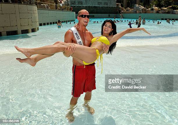 Lifeguard Mike Lukowski holds up Miss USA 2010, Rima Fakih, at the Mandalay Bay Beach June 24, 2010 in Las Vegas, Nevada. Fakih will represent the...