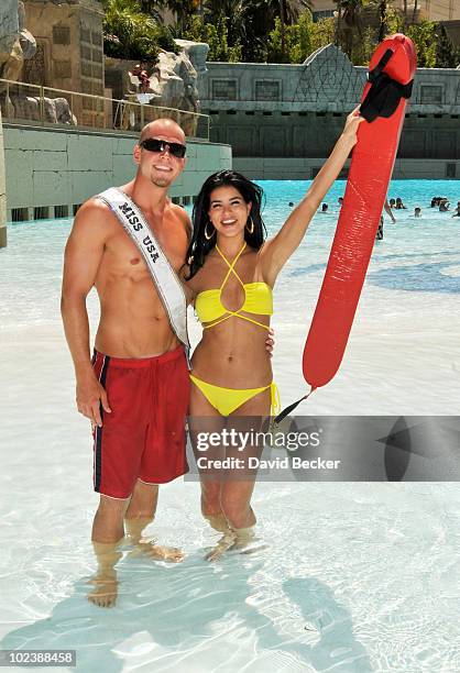 Lifeguard Mike Lukowski poses with Miss USA 2010, Rima Fakih, at the Mandalay Bay Beach June 24, 2010 in Las Vegas, Nevada. Fakih will represent the...