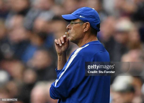 Maurizio Sarri, Manager of Chelsea smokes a cigarette as he looks on during the Premier League match between Newcastle United and Chelsea FC at St....