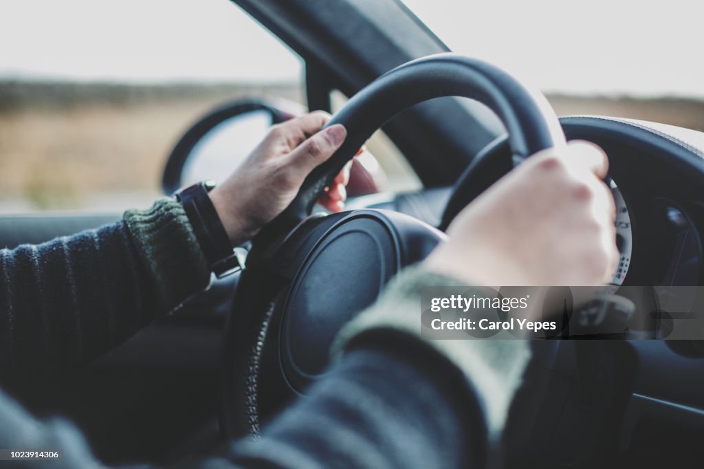 Male hands driving.Travel concept