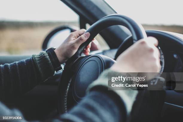 male hands driving.travel concept - steering wheel 個照片及圖片檔