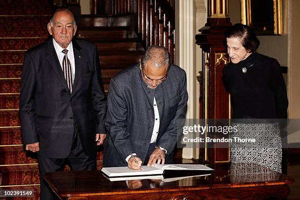 Dr Jose Ramos-Horta, President of the Democratic Repulic of Timor-Leste, signs the guest book of Government House accompanied by Her Excellency...