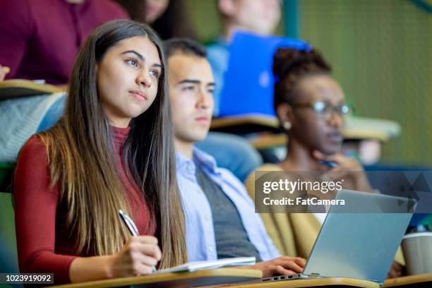 paying attention in class - lecture hall stock pictures, royalty-free photos & images