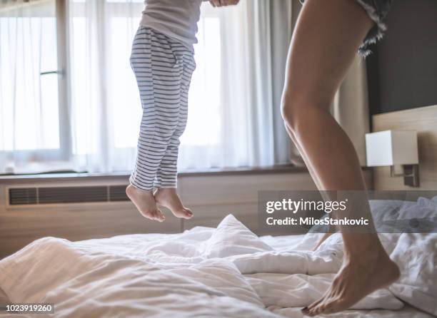 let's jump together - family on bed stock pictures, royalty-free photos & images