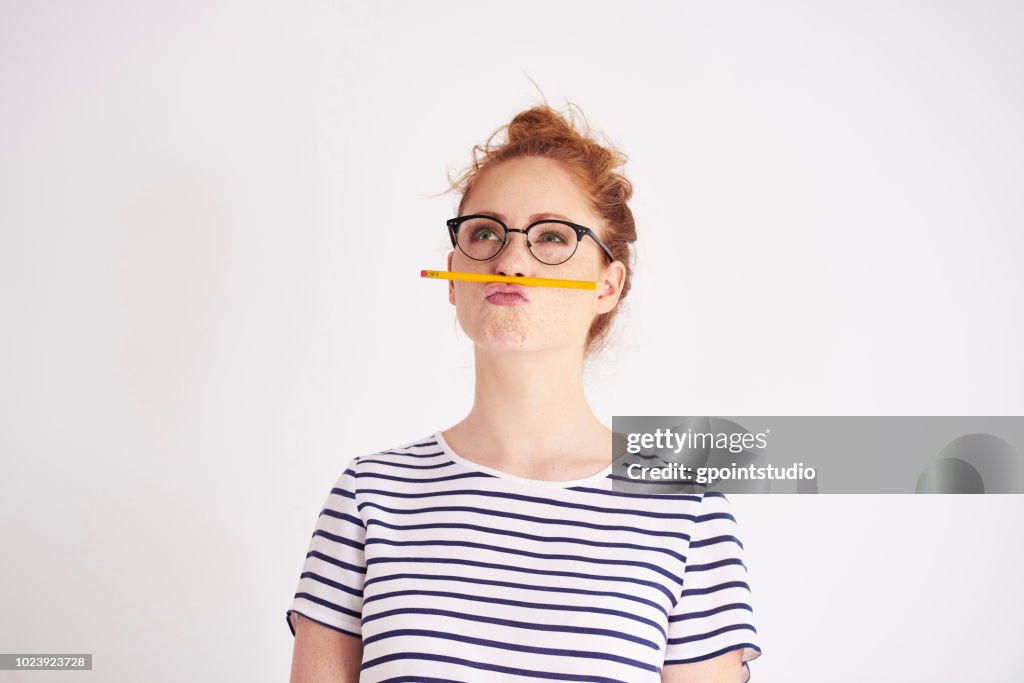 Bored woman having fun with pencil