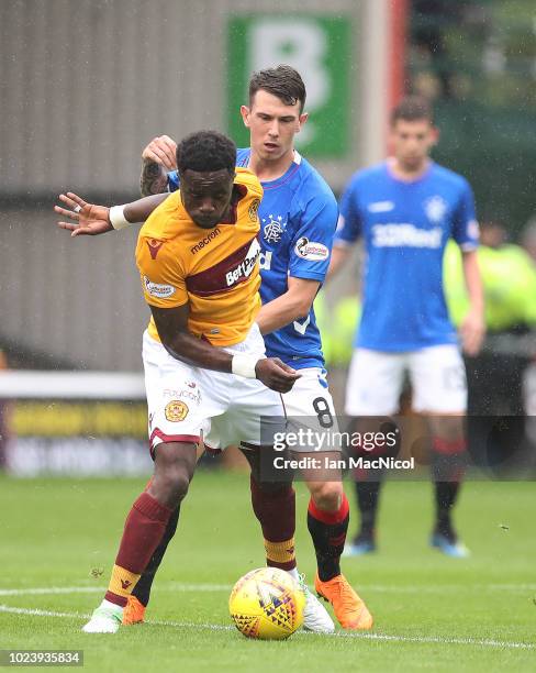 Gaël Bigirimana of Motherwell vies with Ryan Jack of Rangers during the Scottish Premier League match between Motherwell and Rangers at Fir Park on...