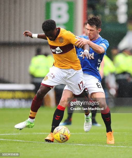 Gaël Bigirimana of Motherwell vies with Ryan Jack of Rangers during the Scottish Premier League match between Motherwell and Rangers at Fir Park on...