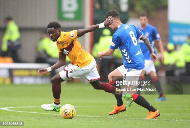 Gaël Bigirimana of Motherwell vies with Ryan Jack of Rangers during the Scottish Premier League match between Motherwell and Rangers at Fir Park on...