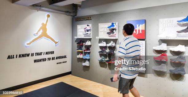 Hong Kong, Hong Kong A shopper looks at Nike Air Jordan basketball shoes at the Nike retail store on August 23 2018 in Hong Kong, Hong Kong