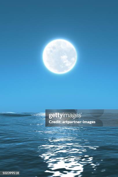 full moon glow shinning with the sea at night - maanlicht stockfoto's en -beelden