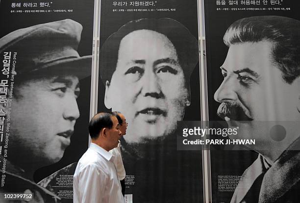 An elderly South Korean visitor passes by the portraits of North Korea's late president Kim Il-Sung , former Chinese leader Mao Zedong and former...