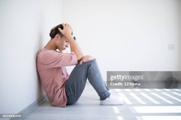 sadness young male - teen mental illness stock pictures, royalty-free photos & images