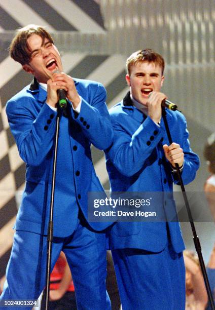 Robbie Williams and Gary Barlow Of Take That perform 'The Beatles' medley at the Brit Awards 1994 at Alexandra Palace, London.