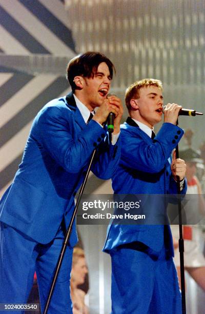 Robbie Williams and Gary Barlow Of Take That perform 'The Beatles' medley at the Brit Awards 1994 at Alexandra Palace, London.