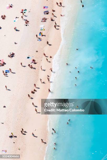 aerial view of beach in summer with people. zakynthos, greek islands, greece - crowd of people from above stock pictures, royalty-free photos & images