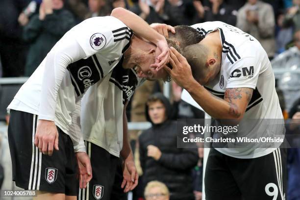 Andre Schurrle of Fulham celebrates scoring their 4th goal with Luciano Vietto and Aleksandar Mitrovic during the Premier League match between Fulham...