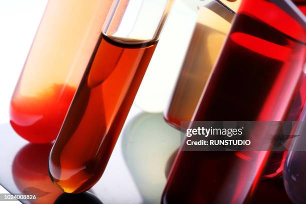 test tubes with colored liquids - blood testing photos et images de collection