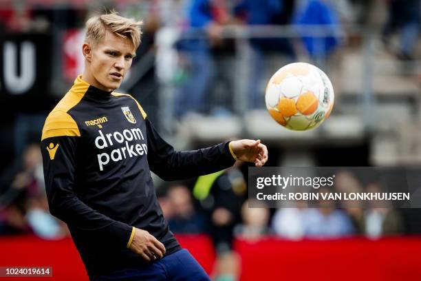 Vitesse Arnhem's Martin Odegaard warms up prior to the Dutch Eredivisie football match between AZ Alkmaar and Vitesse Arnhem in Alkmaar on August 26,...