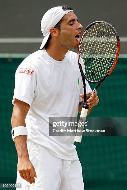 Albert Montanes of Spain licks his racquet during his match against Novak Djokovic of Serbia on Day Five of the Wimbledon Lawn Tennis Championships...