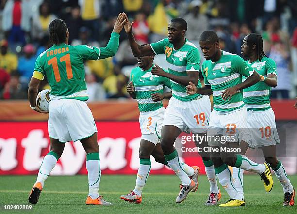 Yaya Toure of the Ivory Coast celebrates scoring the opening goal with Didier Drogba and team mates during the 2010 FIFA World Cup South Africa Group...