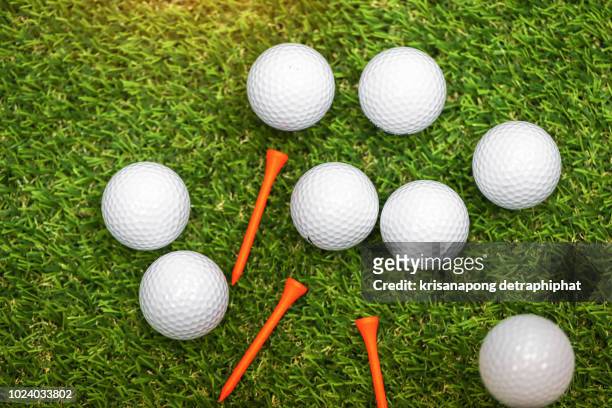 close up of a white golf ball on green background - golf club stock pictures, royalty-free photos & images