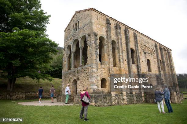 Tourists observe the Church of Santa Maria de Naranco of prerromanesque stile on July 25, 2018 in Oviedo, Spain.