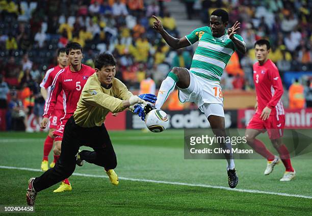 Ri Myong-Guk of North Korea and Abdul Kader Keita of the Ivory Coast battle for the ball during the 2010 FIFA World Cup South Africa Group G match...