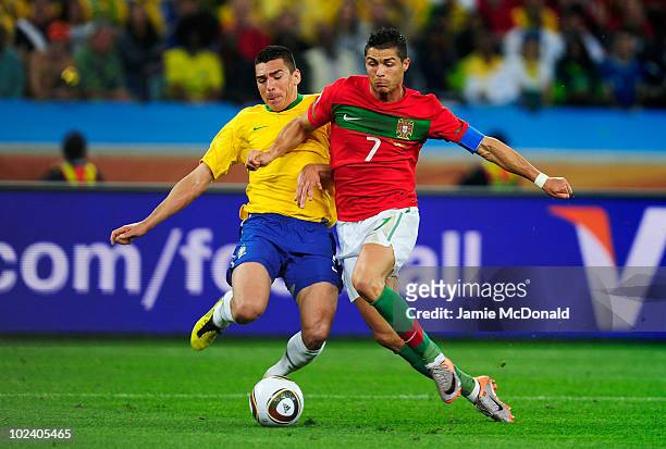 Lucio of Brazil tackles Cristiano Ronaldo of Portugal during the 2010 FIFA World Cup South Africa Group G match between Portugal and Brazil at Durban...