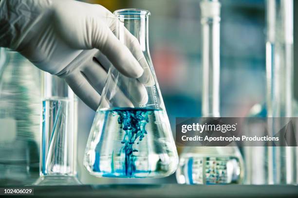 mixing of two liquids in erlenmeyer flask - measuring cylinder stock pictures, royalty-free photos & images