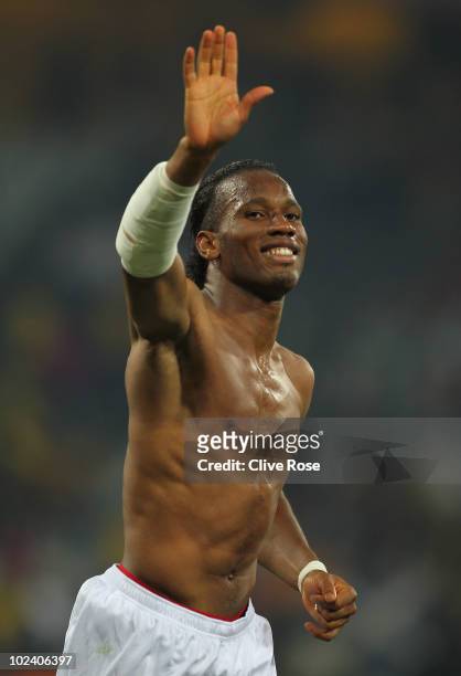 Dejected Didier Drogba of the Ivory Coast raises a smile and waves to fans after victory in the game but elimination from the tournament during the...