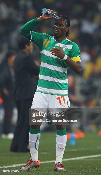 Didier Drogba of the Ivory Coast pours water over his face during the 2010 FIFA World Cup South Africa Group G match between North Korea and Ivory...