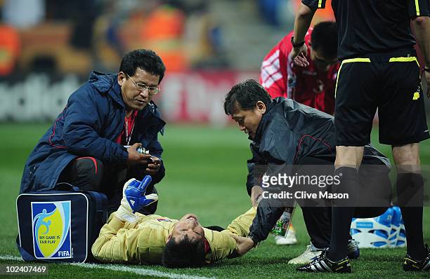 Ri Myong-Guk of North Korea receives treatment during the 2010 FIFA World Cup South Africa Group G match between North Korea and Ivory Coast at the...