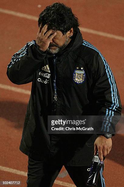 Argentina's head coach Diego Maradona wipes his face as he leaves the pitch after a during a team training session on June 23, 2010 in Pretoria,...