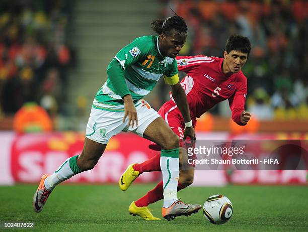 Didier Drogba of Ivory Coast is challenged by Ri Kwang-Chon of North Korea during the 2010 FIFA World Cup South Africa Group G match between North...