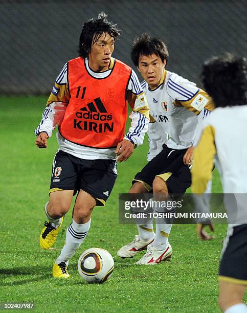 Japan's midfielder Shunsuke Nakamura dribbles the ball in front of forward Shinji Okazaki during their training session at the Outeniqua stadium in...