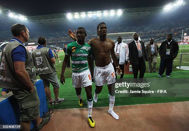 Didier Drogba and Salomon Kalou of Ivory Coast walk back to the dressing room after the 2010 FIFA World Cup South Africa Group G match between North...