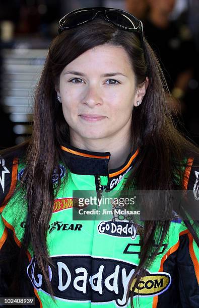 Danica Patrick, driver of the GoDaddy.com Chevrolet, stands in the garage prior to pactice for the NASCAR Nationwide Series New England 200 at the...