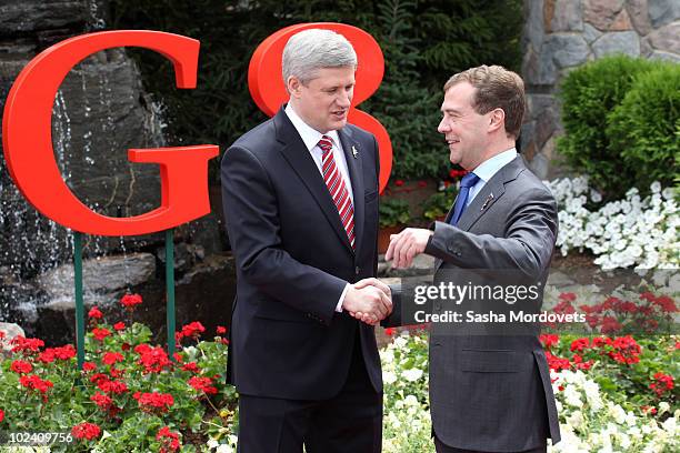 Canadian Prime Minister Stephen Harper greets Russian President Dmitry Medvedev during a welcoming ceremony at the G-8 summit at the Deerhurst Resort...