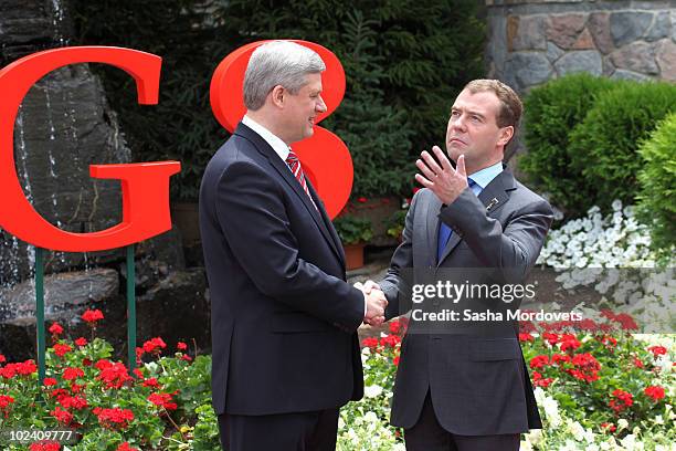 Canadian Prime Minister Stephen Harper greets Russian President Dmitry Medvedev during a welcoming ceremony at the G-8 summit at the Deerhurst Resort...