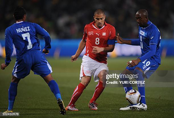 Switzerland's midfielder Goekhan Inler challenges Honduras' midfielder Jerry Palacios for the ball during the Group H first round 2010 World Cup...