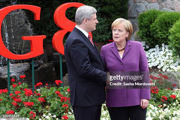 Canadian Prime Minister Stephen Harper greets German Chancellor Angela Merkel during a welcoming ceremony at the G-8 summit at the Deerhurst Resort...
