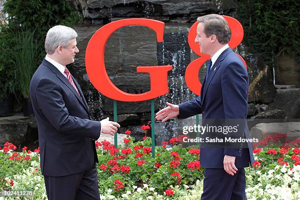 Canadian Prime Minister Stephen Harper greets British Prime Minister David Cameron during a welcoming ceremony at the G-8 summit at the Deerhurst...