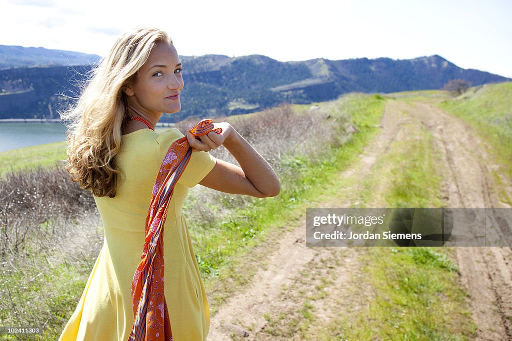 A beautiful woman holding a scarf. 