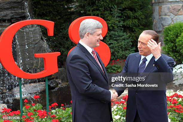 Canadian Prime Minister Stephen Harper greets Italian Prime Minister Silvio Berlusconi during a welcoming ceremony at the G-8 summit at the Deerhurst...