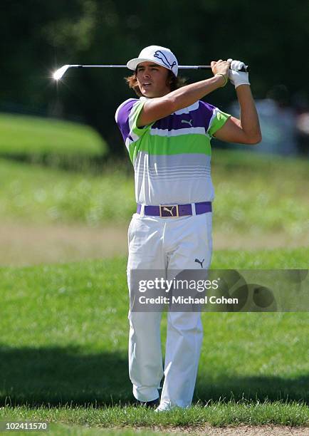 Rickie Fowler hits a shot from the rough during the second round of the Travelers Championship held at TPC River Highlands on June 25, 2010 in...