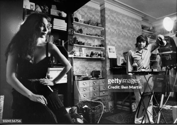 English photographer David Bailey photographing fashion model Marie Helvey at home in London, August 8th 1977.