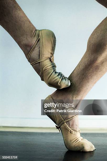 male ballet dancer balancing on toe. - ballerina feet stock-fotos und bilder